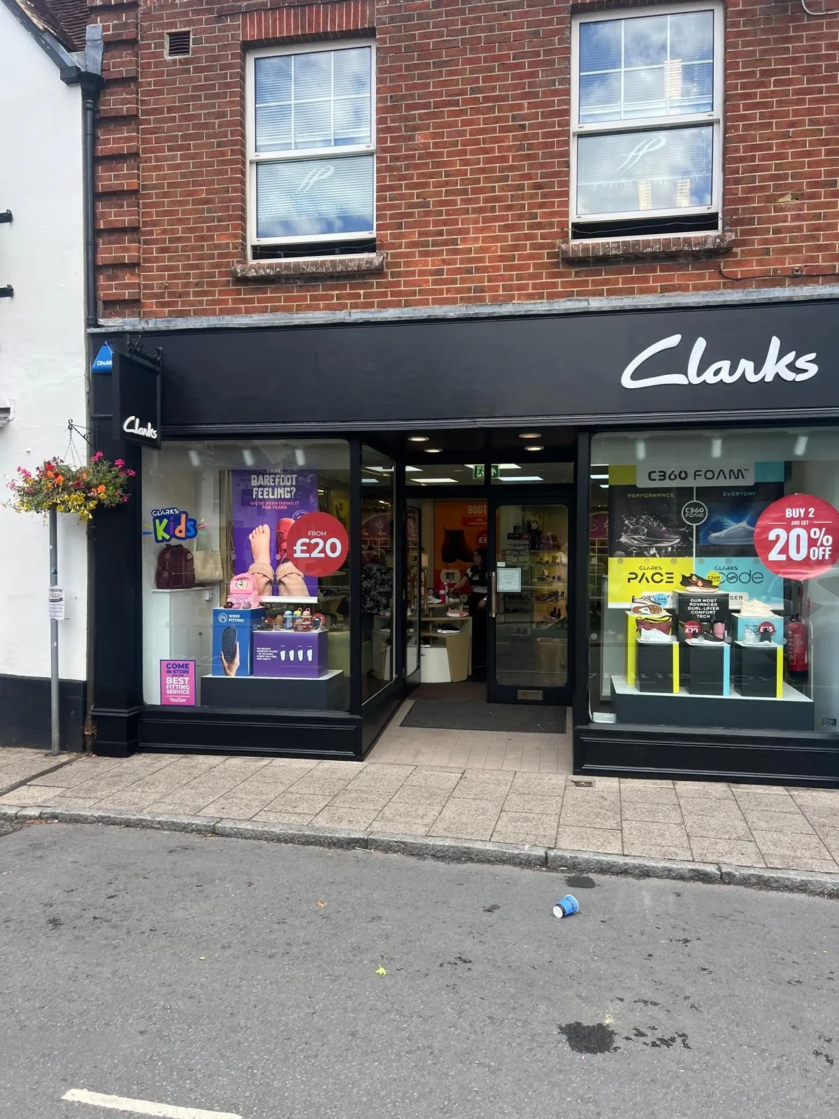Dark painted shop front on a red brick building